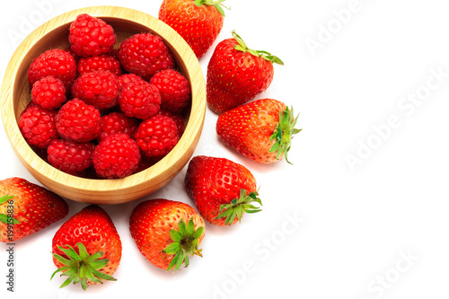 Fresh raspberry in a wooden bowl and strawberry isolated on white background with copy space. Healthy snack eating for diet.