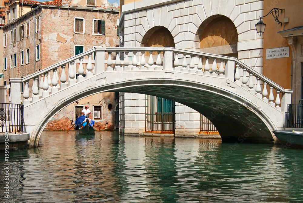 Gondola ride towards bridge in Venice, Italy.