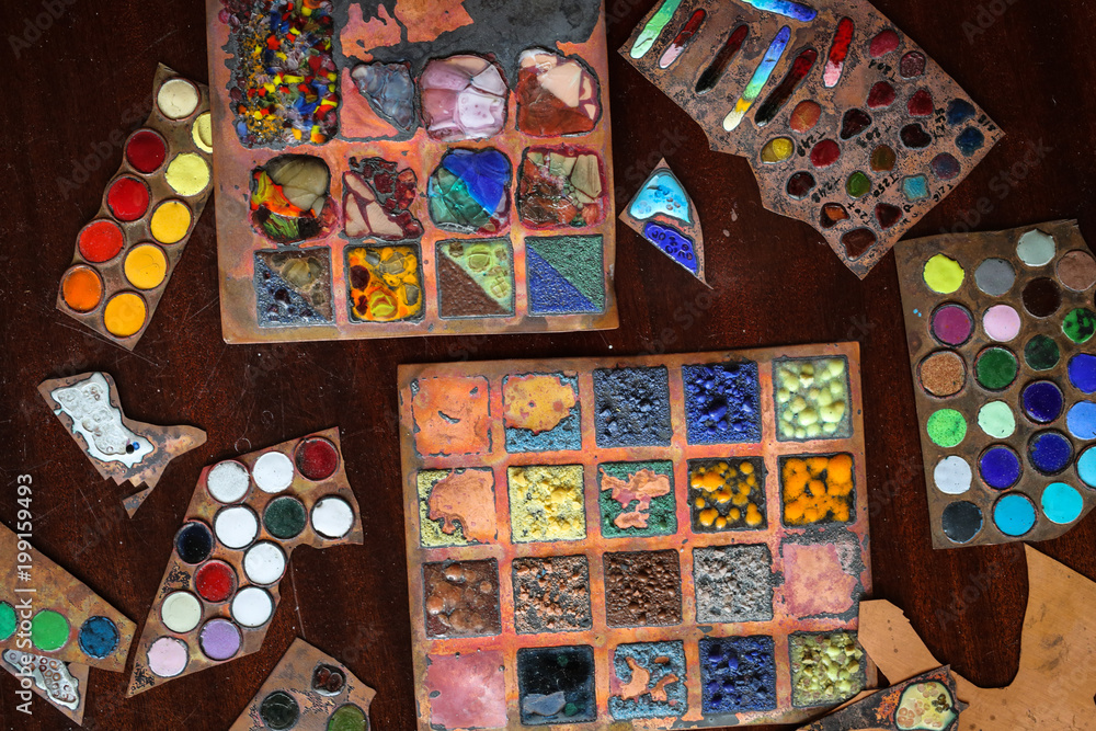 Multicolored enamel samples on metal, top view