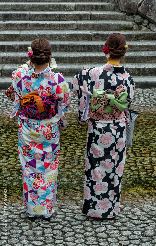 Two geishas walking on a street in Kyoto, Japan