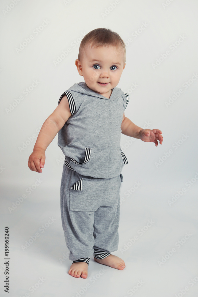 Little boy doing exercise in Studio on white background