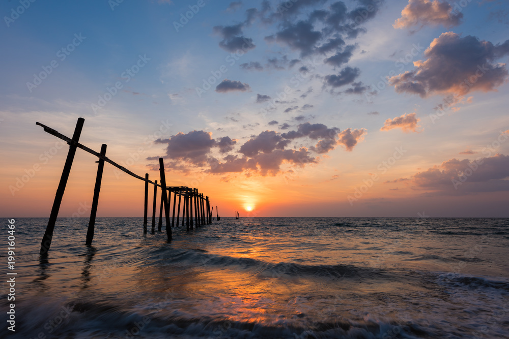 Old wooden bridge in sea on sunset at Phang Nga Province, Thailand