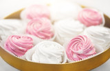 food, confection and sweets concept - close up of zephyr, marshmallow or whipped cream on cake stand