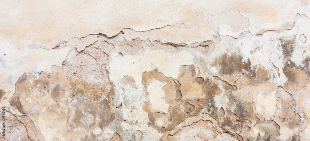 Fototapeta premium Old white plaster wall with cracked shabby surface texture background.