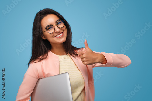 Photography Stylish student with laptop showing thump up