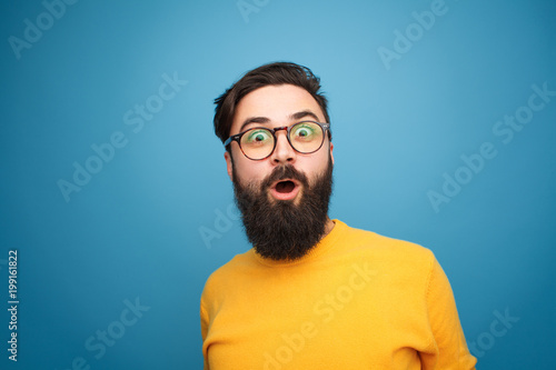 Super excited bearded hipster looking at camera photo