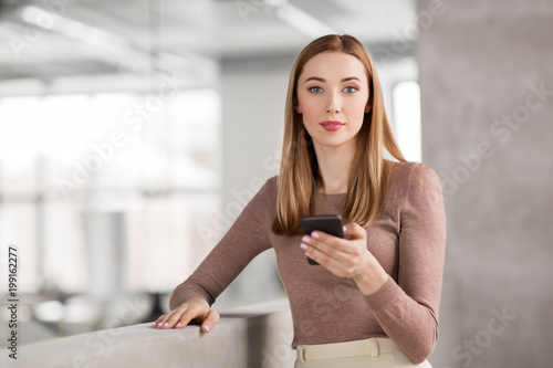 Wallpaper Mural business people, technology and corporate concept - happy smiling businesswoman with smartphone at office Torontodigital.ca