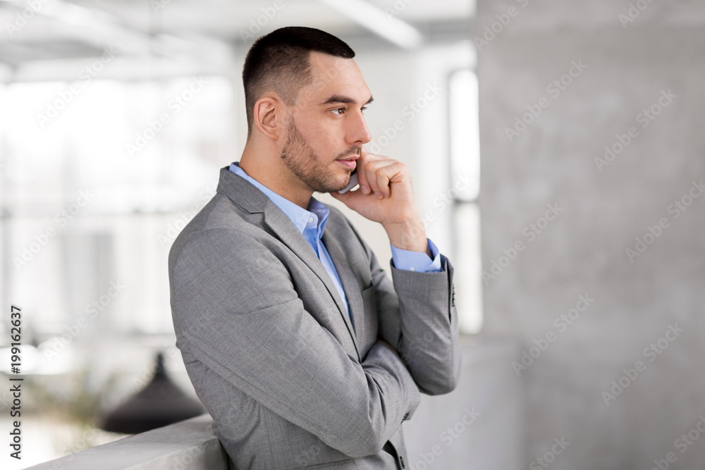 business people, technology and corporate concept - businessman calling on smartphone at office business people, technology and corporate concept - businessman calling on smartphone at office