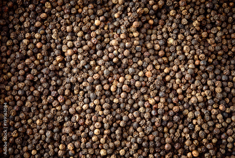 Peppercorn background. Dry black pepper seeds. Top view. Peppercorn background. Dry black pepper seeds. Top view.