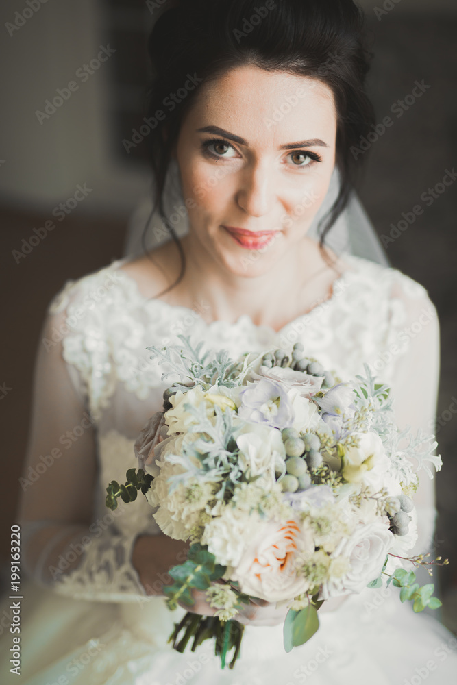 Bride holding big and beautiful wedding bouquet with flowers