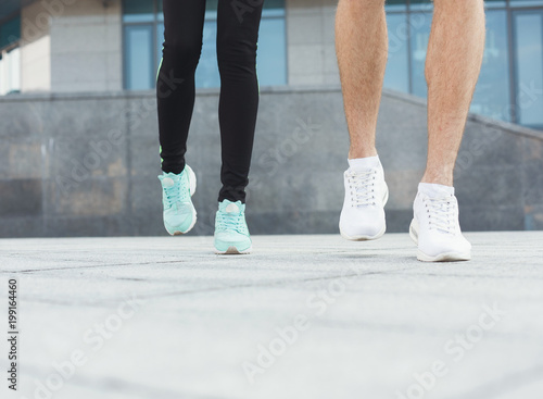 Closeup of male and female feet running © Prostock-studio