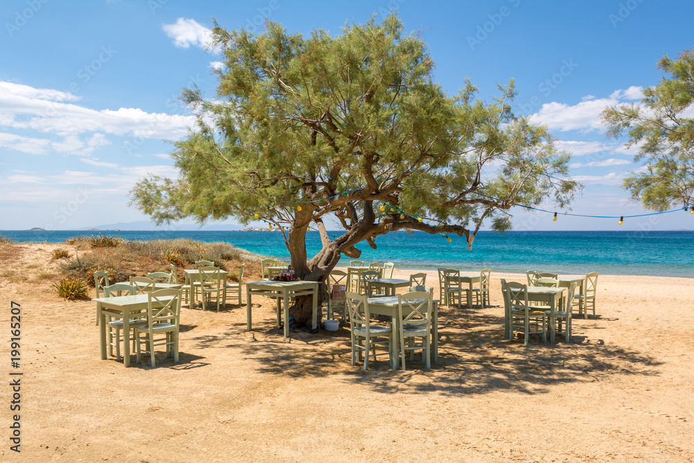 Romantic greek tavern on the Plaka beach. Naxos island, Greece.