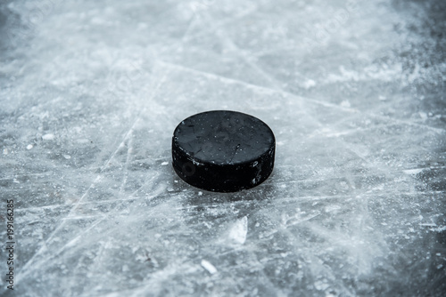 hockey puck lies on the snow close-up