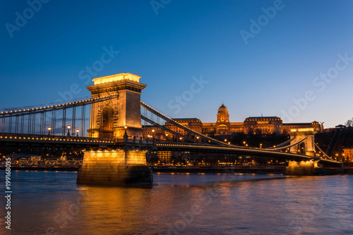 The Chain Bridge with the Royal Palace in the background in Budapest during blue hour