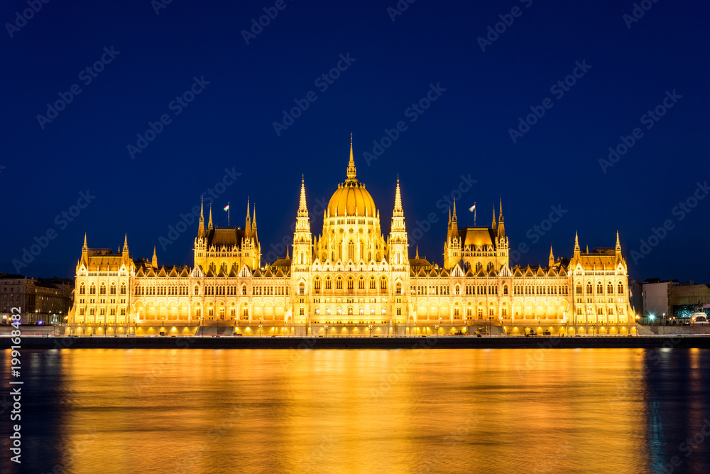 Famous Budapest parliament at the river Danube during blue hour from the front