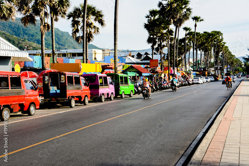 Street trading, tuk-tuk and rent scooters on the srteet in Phuket. Thailand.