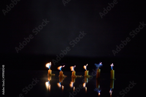 Fading on a dark background candle, scorby and memory photo