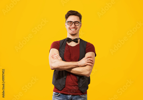 Handsome stylish man on yellow background
