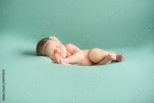 Infant baby girl sleeping on blanket