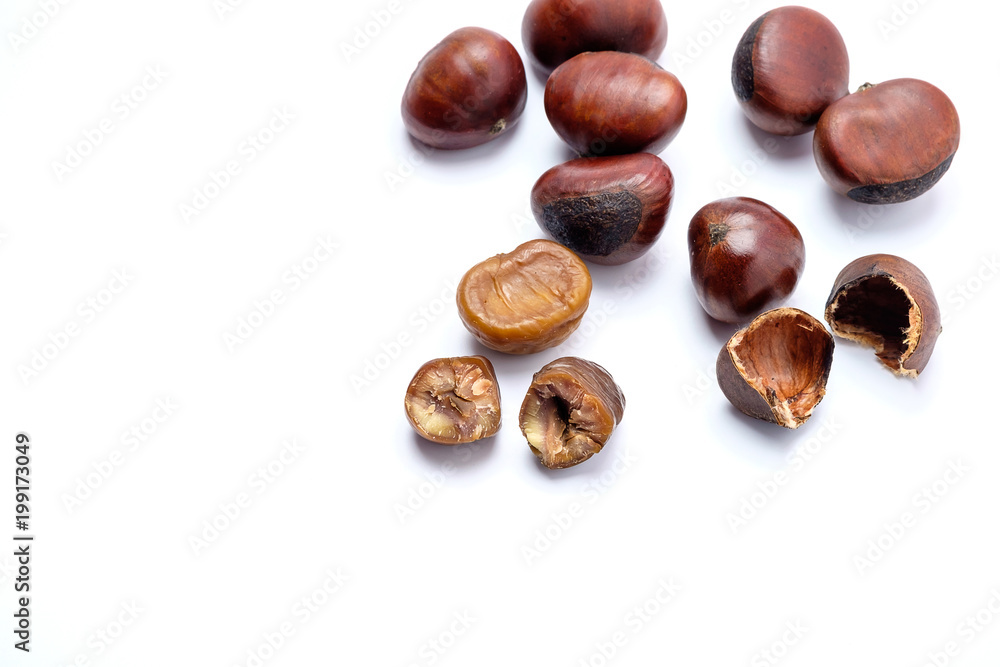 Roasted chestnuts on a white background. Roasted chestnuts on a white background.