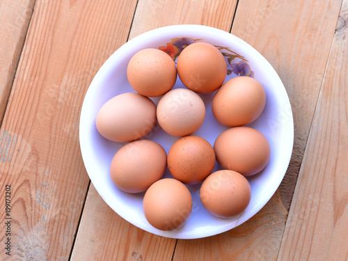 Bowl of eggs on the wooden background