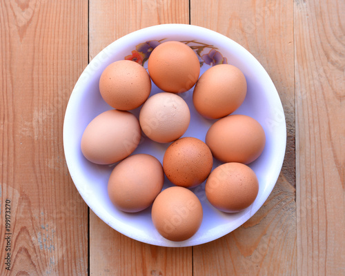 Bowl of eggs on the wooden background