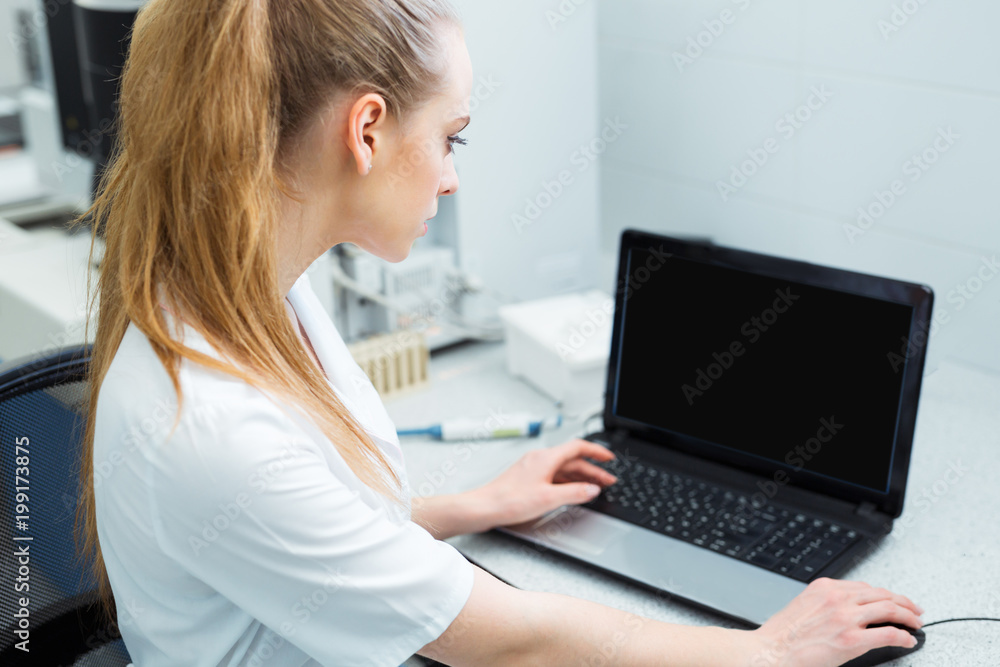 Modern technology in science. Scientist entering data of analysis or research results to laptop at laboratory. Modern technology in science. Scientist entering data of analysis or research results to laptop at laboratory.