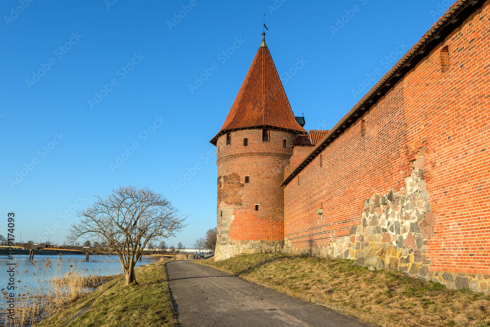 Riverside promenade and exterior towers of Malbork castle.Poland