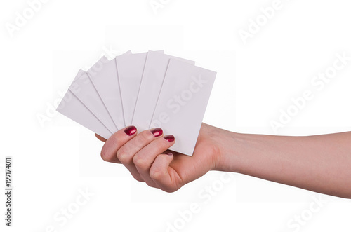 Well-groomed female hand with manicure and red lacquer holding an empty white card