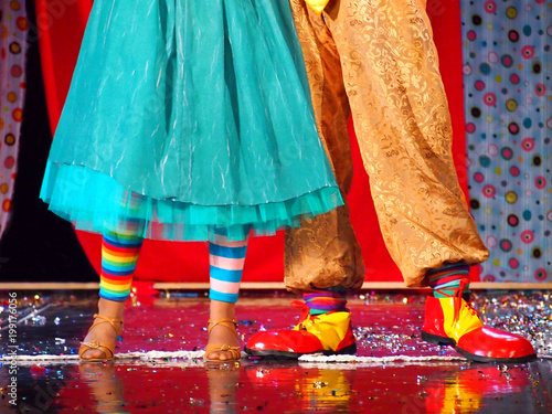 Dancing couple of clowns on stage