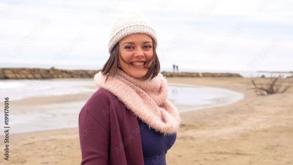 Beautiful woman looking boyfriend calling him to run on beach in spring with hat slow motion closeup Beautiful woman looking boyfriend calling him to run on beach in spring with hat slow motion closeup