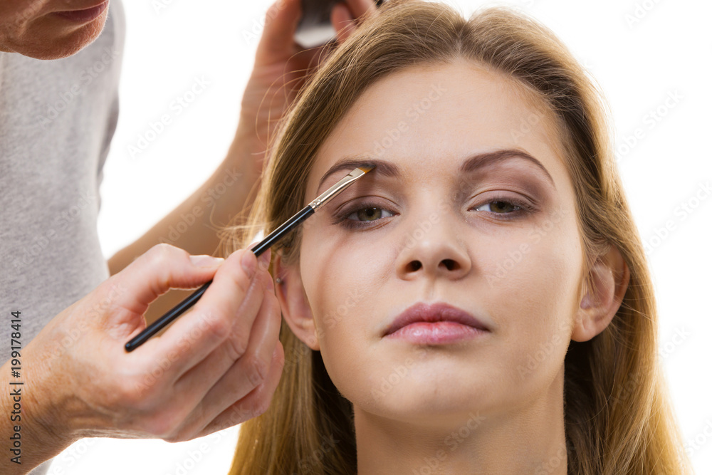 Woman getting eyebrows make up done Woman getting eyebrows make up done