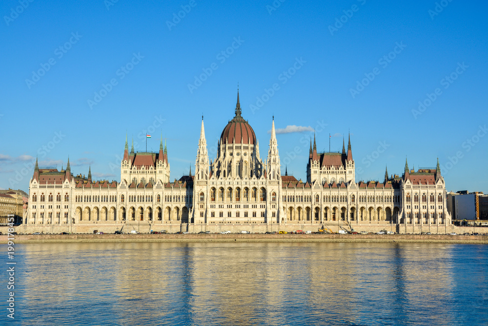 Famous Budapest parliament at the river Danube during sunset from the front