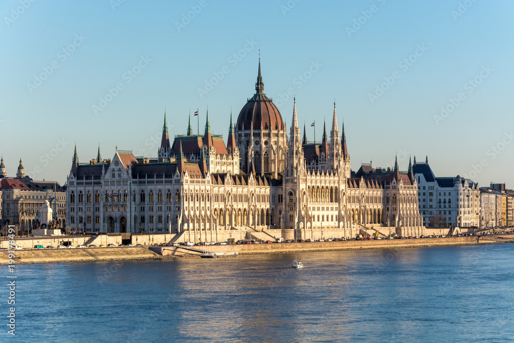 Famous Budapest parliament at the river Danube during sunset from the side