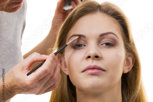 Woman getting eyebrows make up done