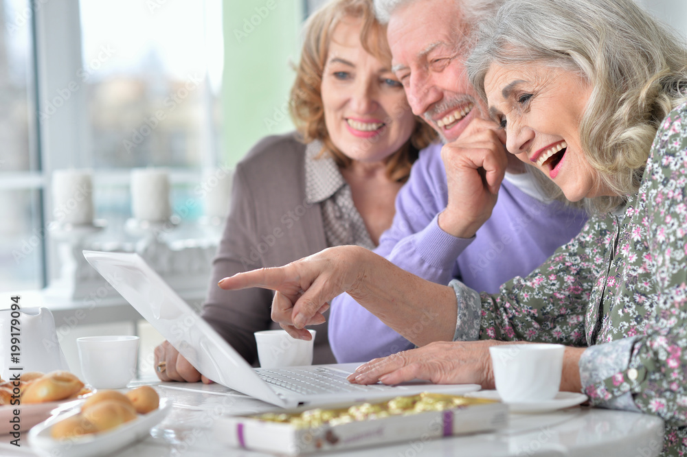 senior people with laptop drinking tea senior people with laptop drinking tea