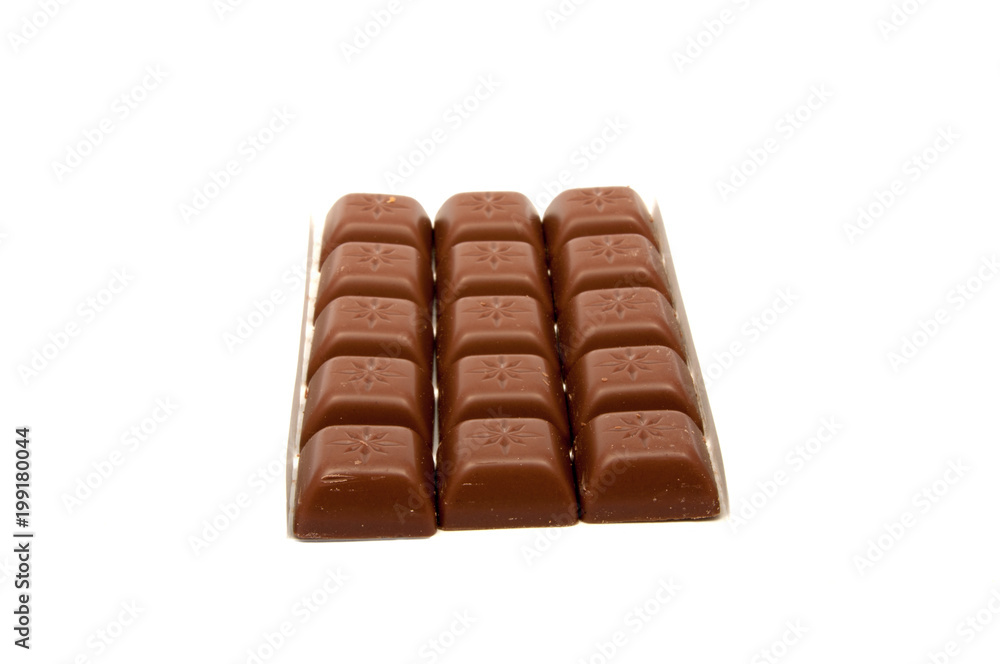 Tasty chocolate in squares on the white Tasty chocolate in squares on the white