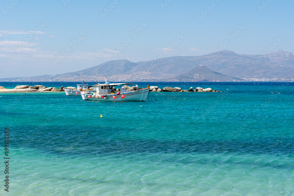 Boat on azure sea water. Agia Anna beach. Naxos island. Greece