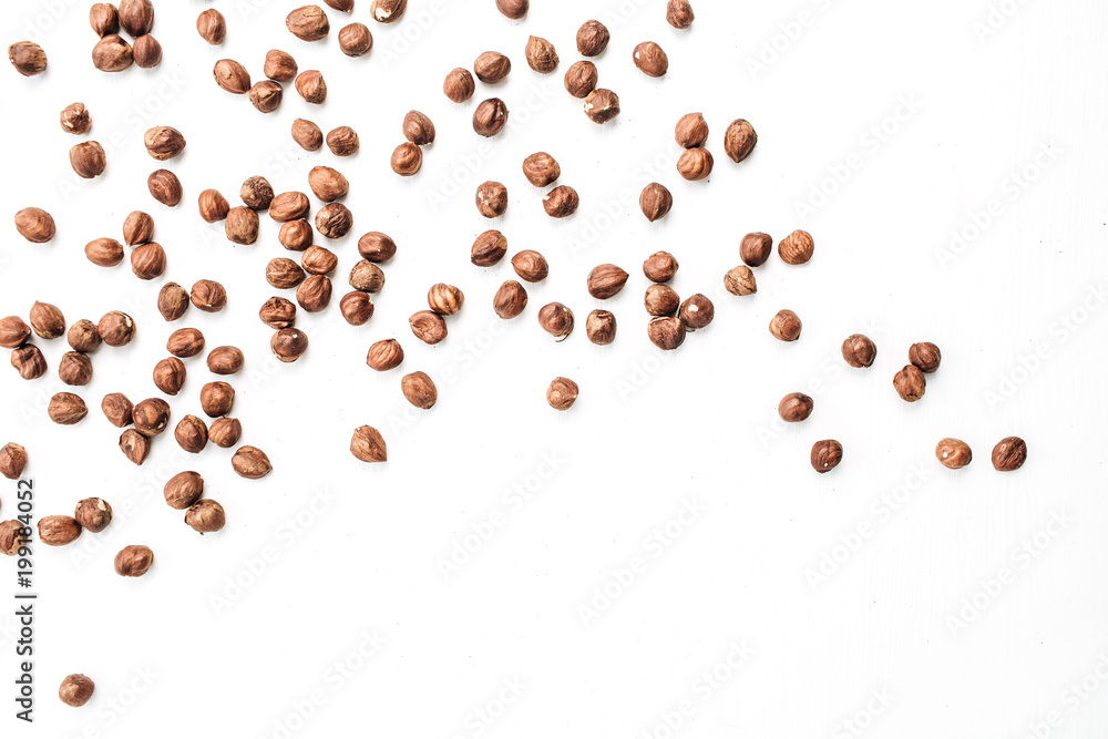 Hazelnut on white background. Flat lay, top view. Hazelnut on white background. Flat lay, top view.