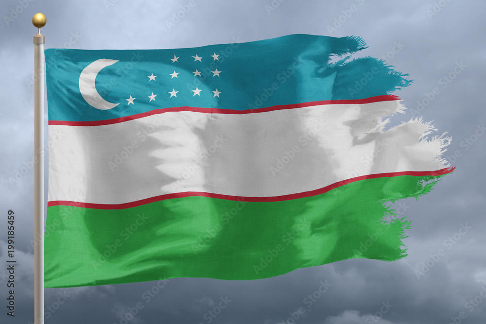 Fototapeta premium Uzbekistan Flag with torn edges in front of a stormy sky