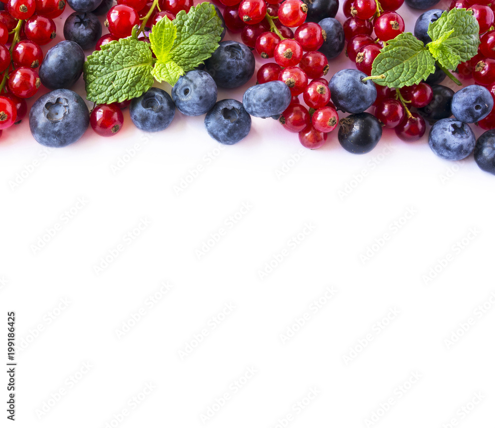 Mix berries and fruits at border of image with copy space for text. Ripe blueberries, blackberries, strawberries, currants and strawberries on white background. Top view. Black-blue and red food. Mix berries and fruits at border of image with copy space for text. Ripe blueberries, blackberries, strawberries, currants and strawberries on white background. Top view. Black-blue and red food.