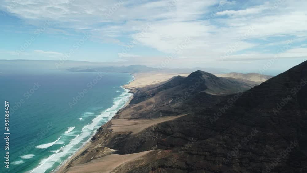 high reverse reveal of a mountain and coastline by drone high reverse reveal of a mountain and coastline by drone