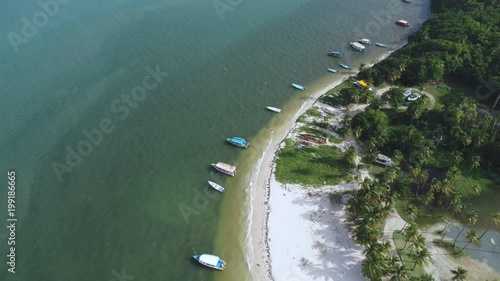 a Caribbean island resort from revealing backwards to show boats and the coastline