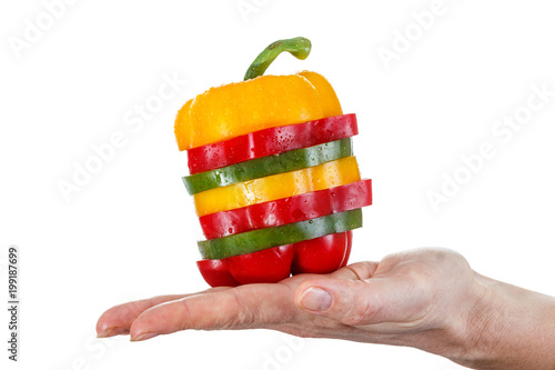 A selection of colorful sweet peppers sliced in pieces to make one pepper on hand