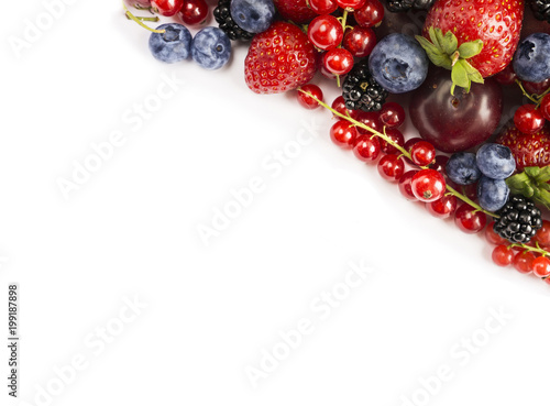 Black-blue and red food. Mix berries on a white background with copy space for text. Ripe blackberries, blueberries, strawberries, red currants and plums on white background. Top view.