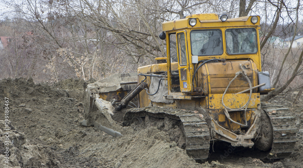 A large bulldozer digs a reclamation channel A large bulldozer digs a reclamation channel