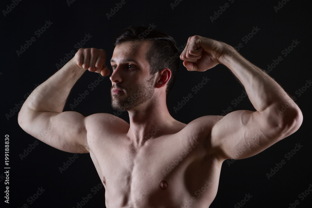 young strong man with muscles on black background young strong man with muscles on black background
