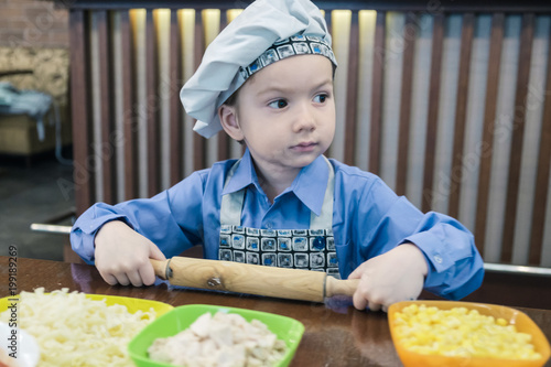 Boy with chef hat preparing...