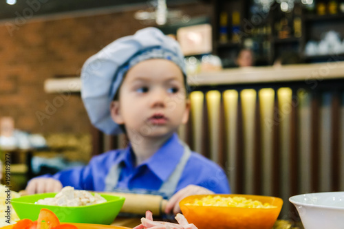 Boy with chef hat preparing...