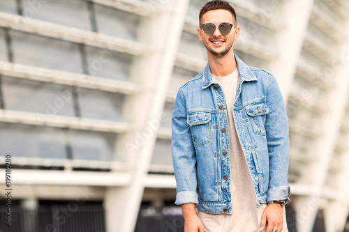 fashion guy posing in sunglasses on sunset